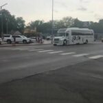 Elk City High School activity bus leaves town on their way to the state championship game