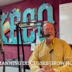 Sheriff Derek Manning seated in KECO studio, wearing yellow button-up shirt, talking into a microphone